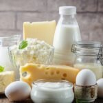Fresh dairy products, milk, cottage cheese, eggs, yogurt, sour cream and butter on wooden table