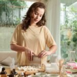 Young woman making organic soap at home for selling online