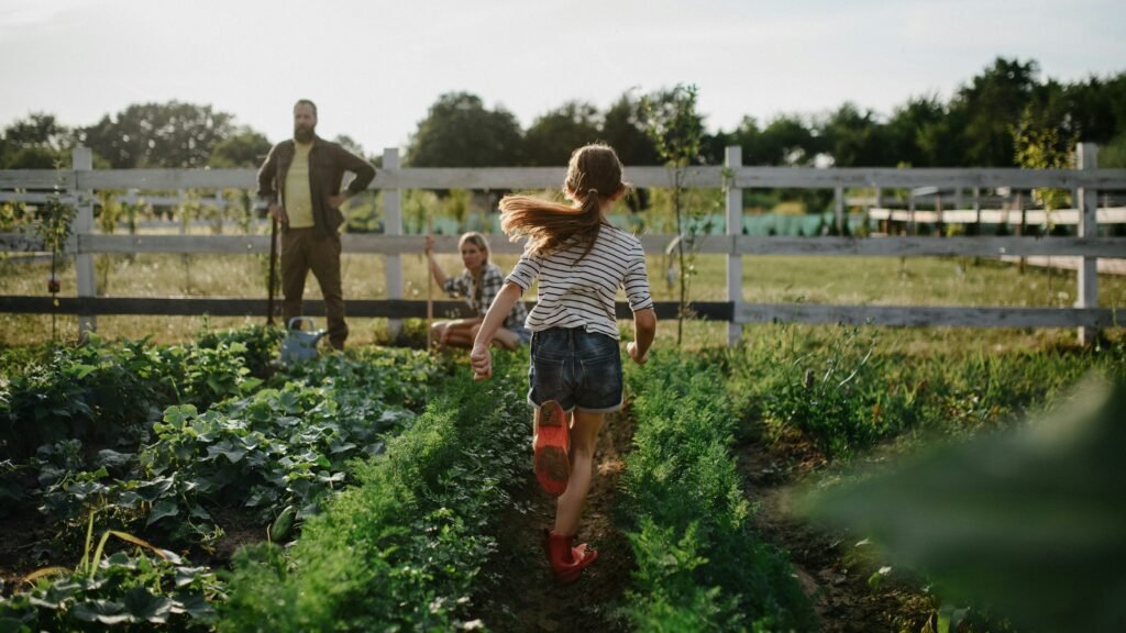 Girl running through a happy vegetable garden