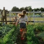 Girl running through a happy vegetable garden