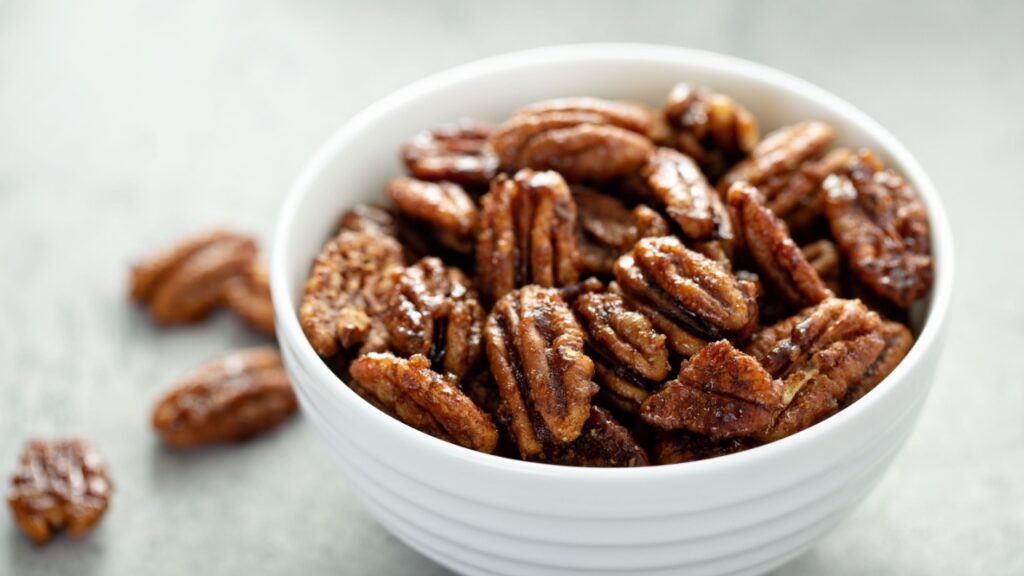 Caramelized or candied pecans for appetizer or salad in white bowl