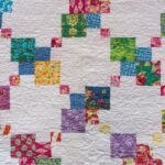 Criss Cross of Color on White Background on Homemade Quilt