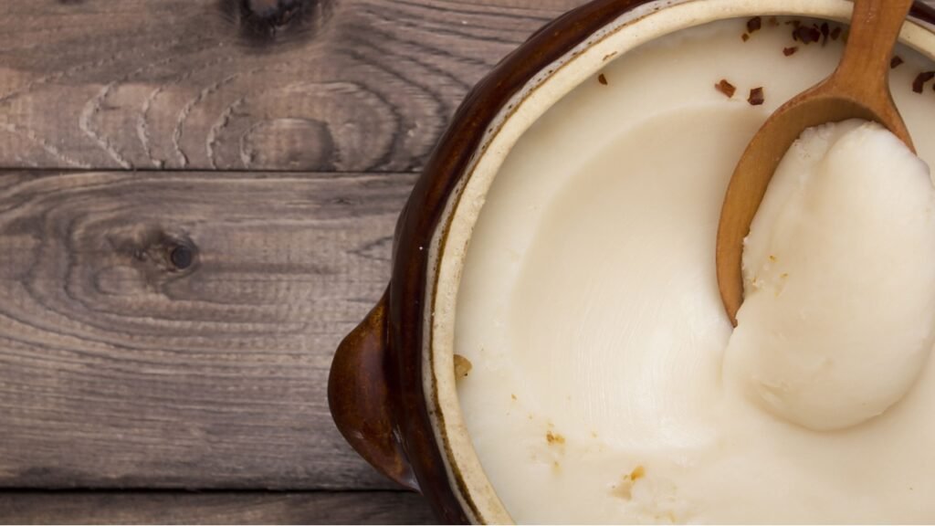 Lard in ceramic bowl with a wooden spoon