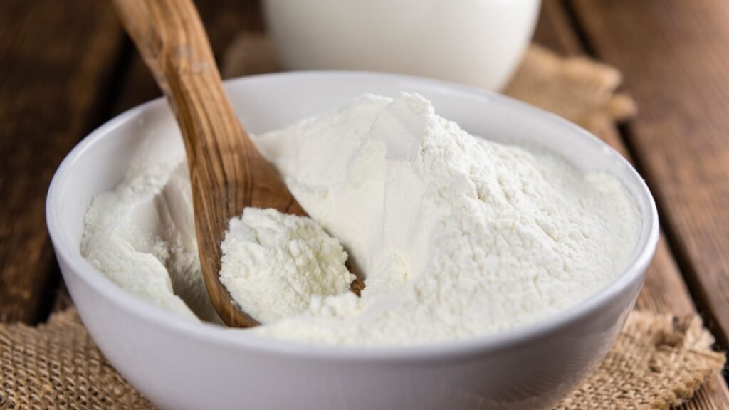 Portion of Milk Powder (selective focus) on an old wooden table