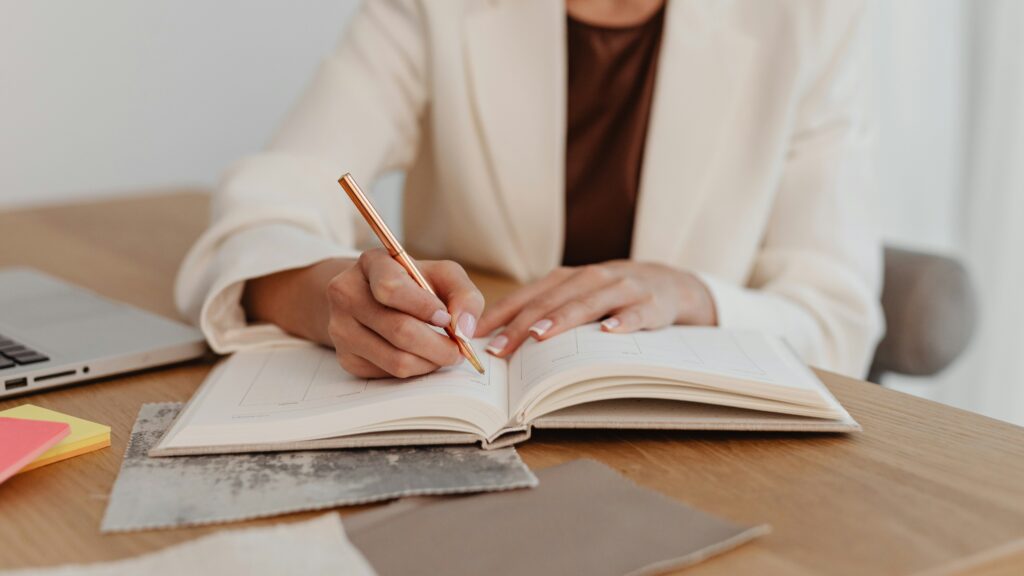 woman journaling making setting goals writing notes intentions