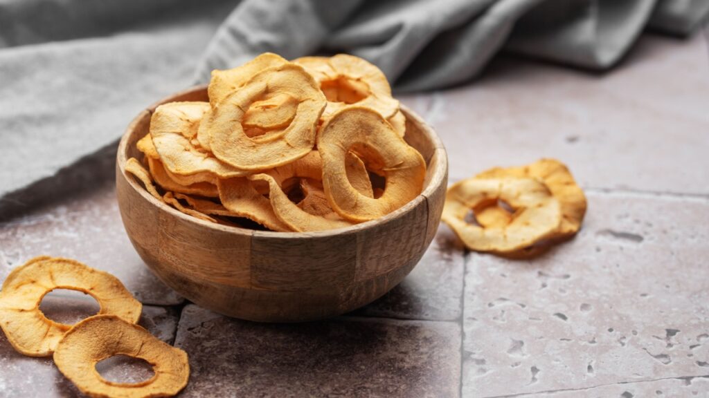Dried apple chips. Dehydrated apples. Homemade dried organic apple sliced.