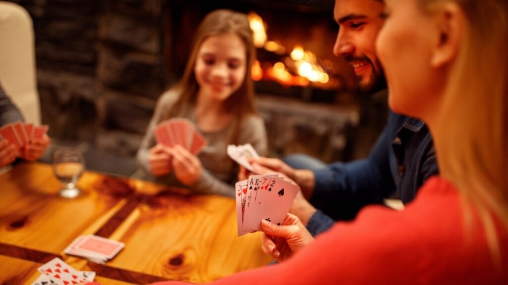 People playing card game at home